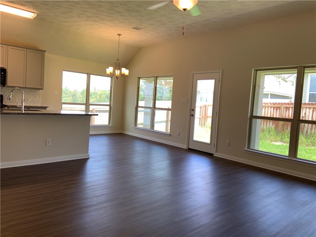 139 Bates Court Huntsville, TX 77320 - Photo 7 of 21 an empty room with wooden floor and windows