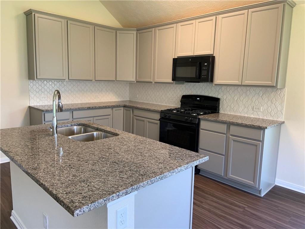 139 Bates Court Huntsville, TX 77320 - Photo 9 of 21 a kitchen with stainless steel appliances granite countertop a sink stove and microwave