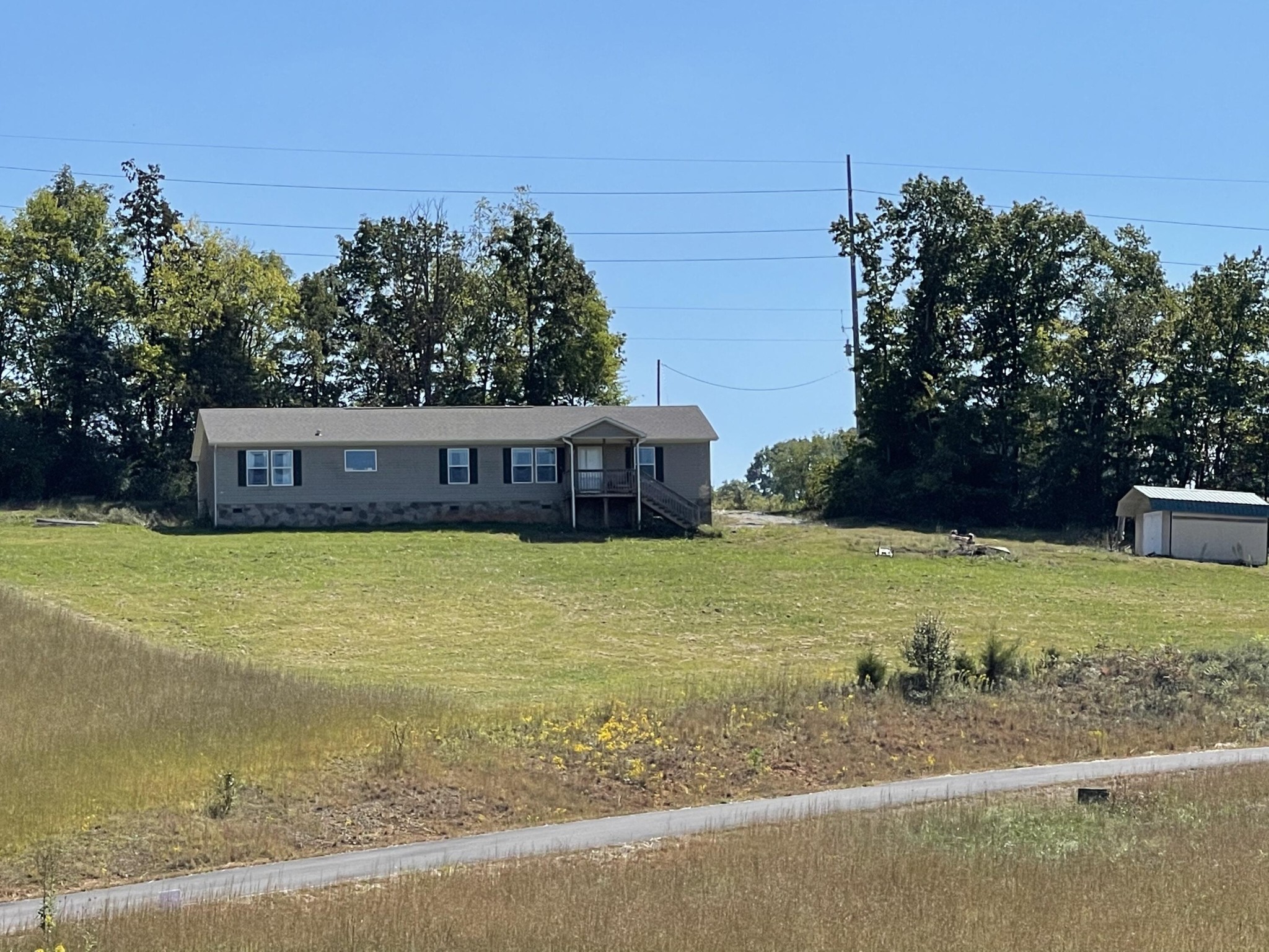 1865 O'Neil Road Newport, TN 37821 - Photo 3 of 19 a front view of a house with a yard and trees