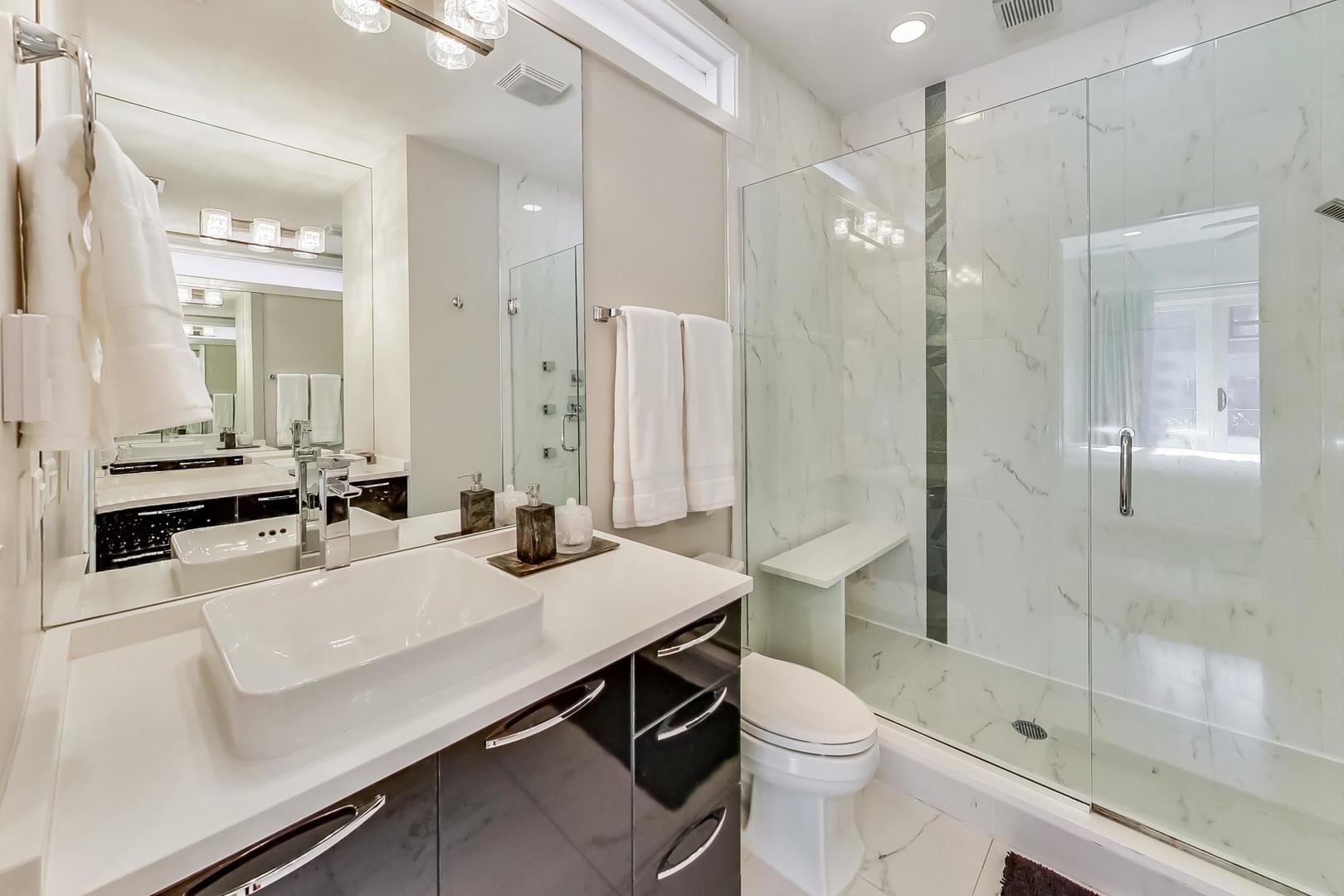 1525 West Fry Street, Unit 2 Chicago, IL 60642 - Photo 15 of 33 a bathroom with a sink a toilet a mirror and shower