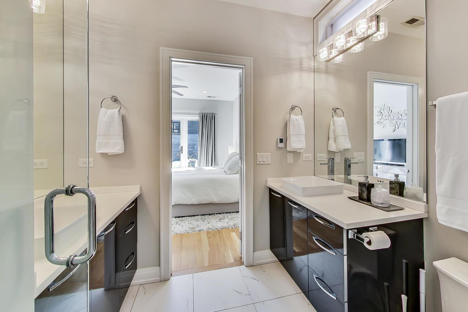 1525 West Fry Street, Unit 2 Chicago, IL 60642 - Photo 16 of 33 a spacious bathroom with a double vanity sink a mirror and shower