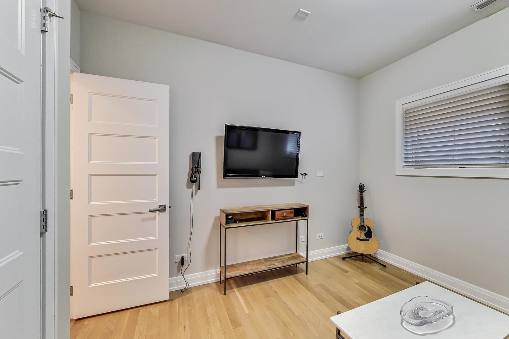 1525 West Fry Street, Unit 2 Chicago, IL 60642 - Photo 21 of 33 a living room with a flat screen tv and a wooden floor