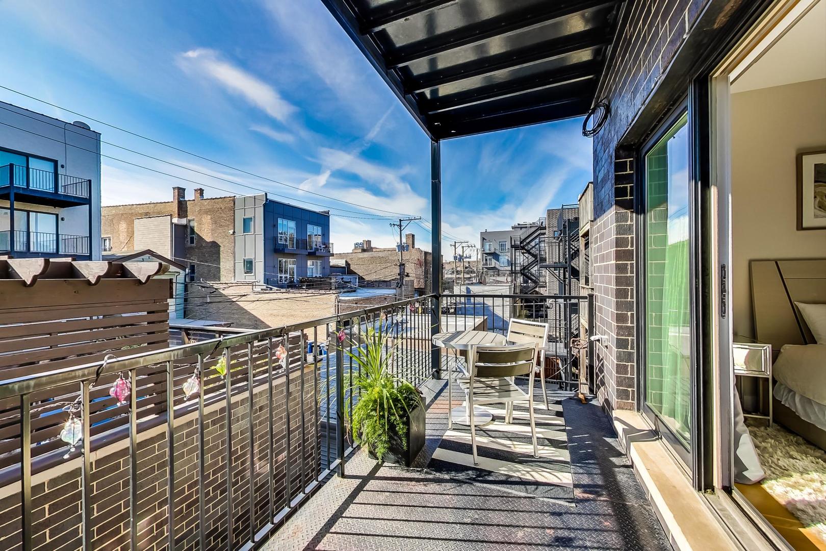 1525 West Fry Street, Unit 2 Chicago, IL 60642 - Photo 24 of 33 a view of a balcony with chairs and wooden floor