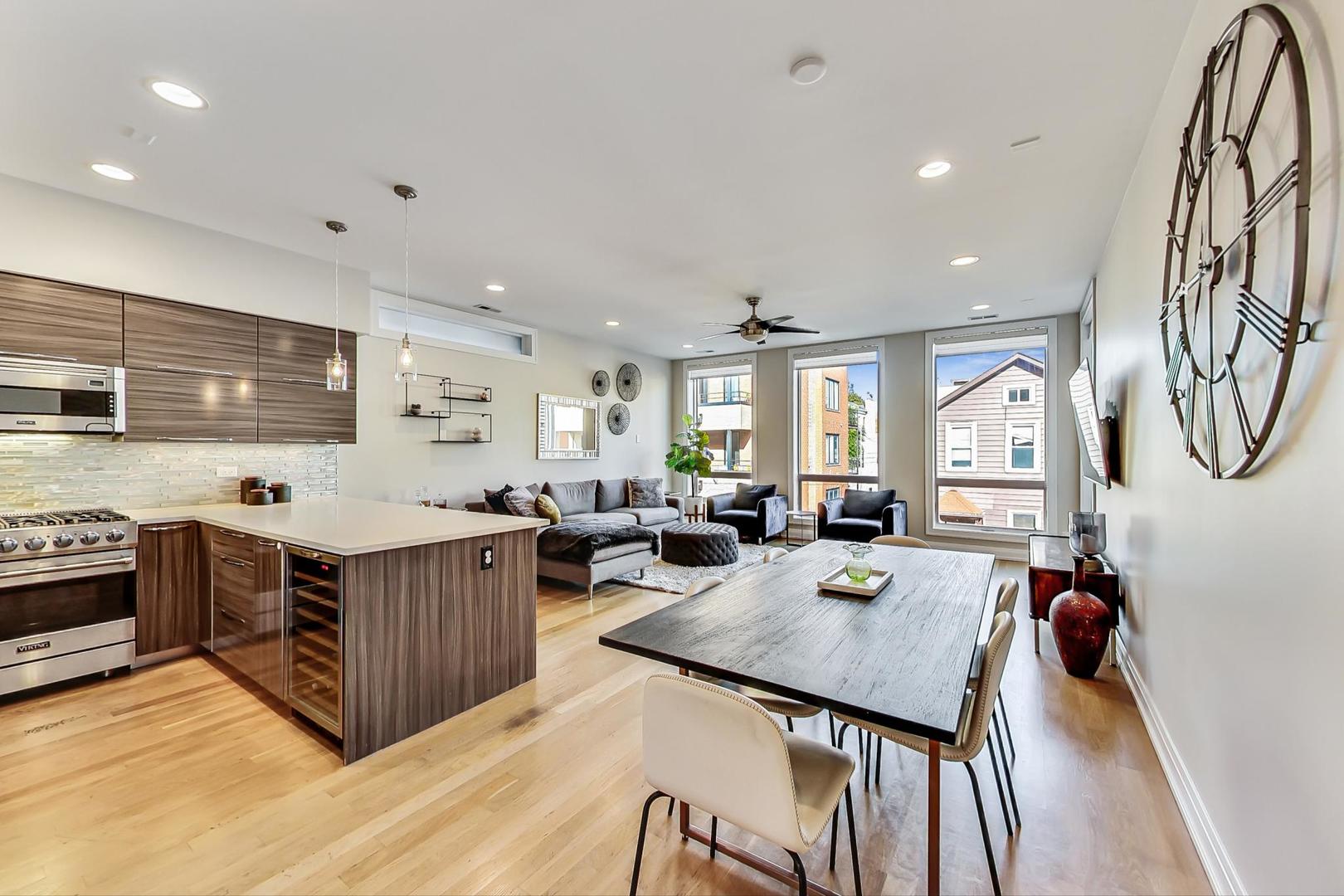 1525 West Fry Street, Unit 2 Chicago, IL 60642 - Photo 6 of 33 a living room with stainless steel appliances granite countertop a table chairs and a refrigerator a sink dishwasher with wooden floor