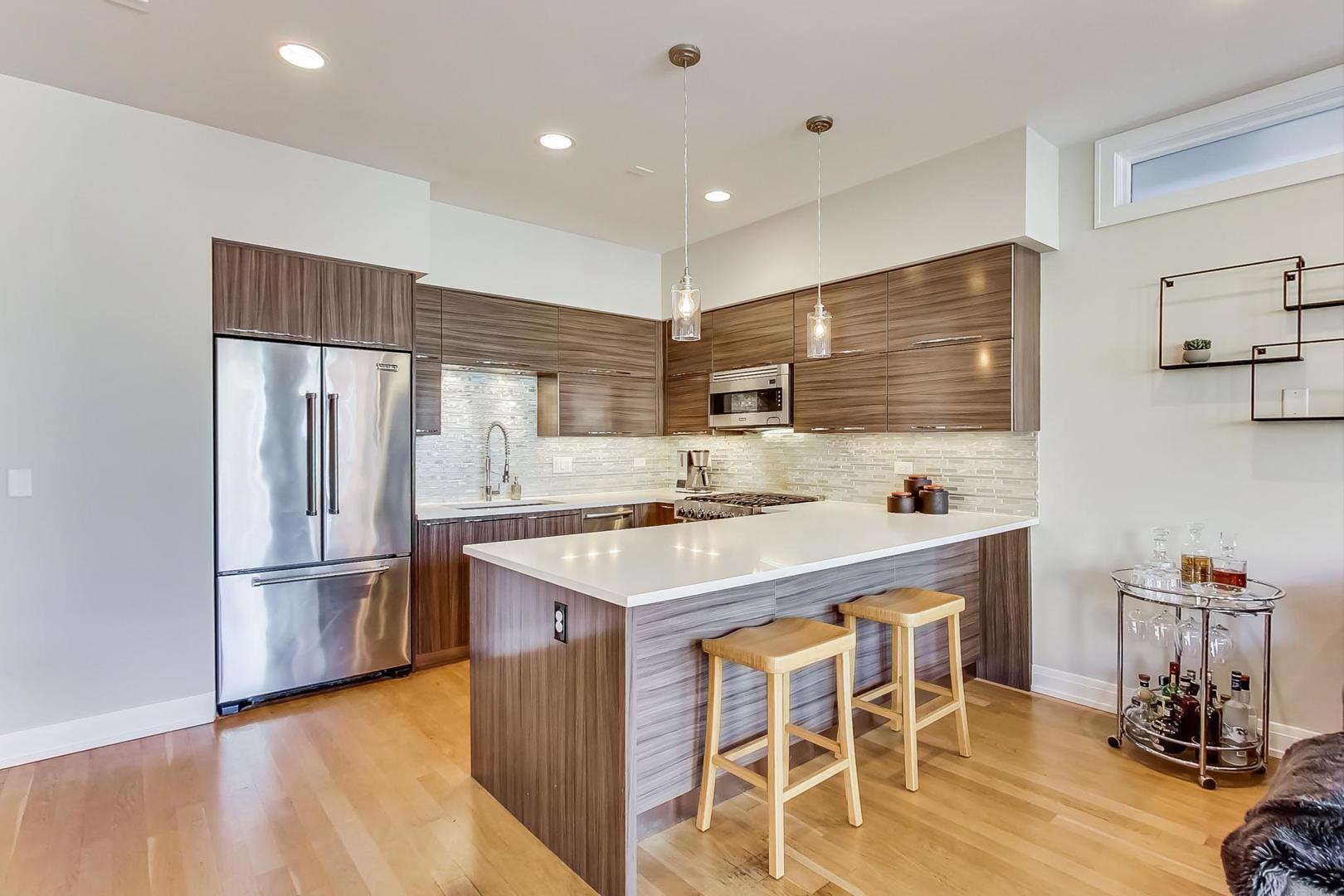 1525 West Fry Street, Unit 2 Chicago, IL 60642 - Photo 9 of 33 a kitchen with stainless steel appliances a stove a refrigerator and a refrigerator