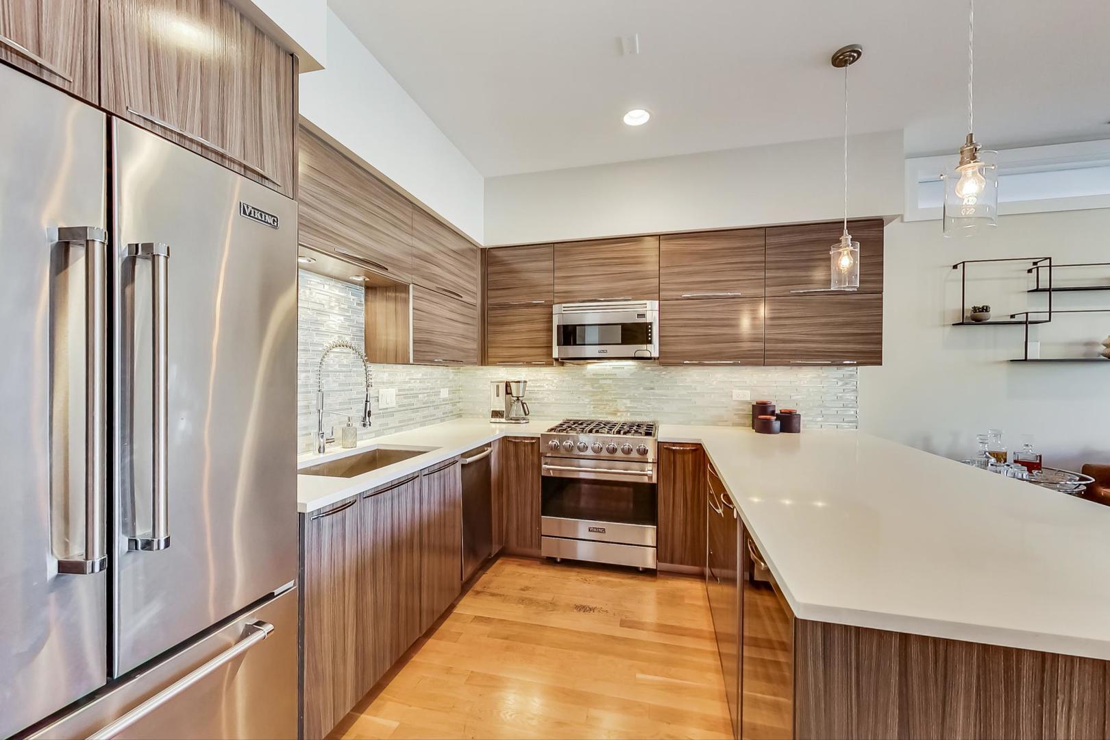 1525 West Fry Street, Unit 2 Chicago, IL 60642 - Photo 10 of 33 a kitchen with stainless steel appliances granite countertop a sink a stove and a refrigerator