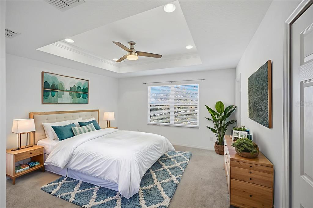 19656 Long Lake Ranch Boulevard Lutz, FL 33558 - Photo 15 of 44 a spacious bedroom with a large bed and a window