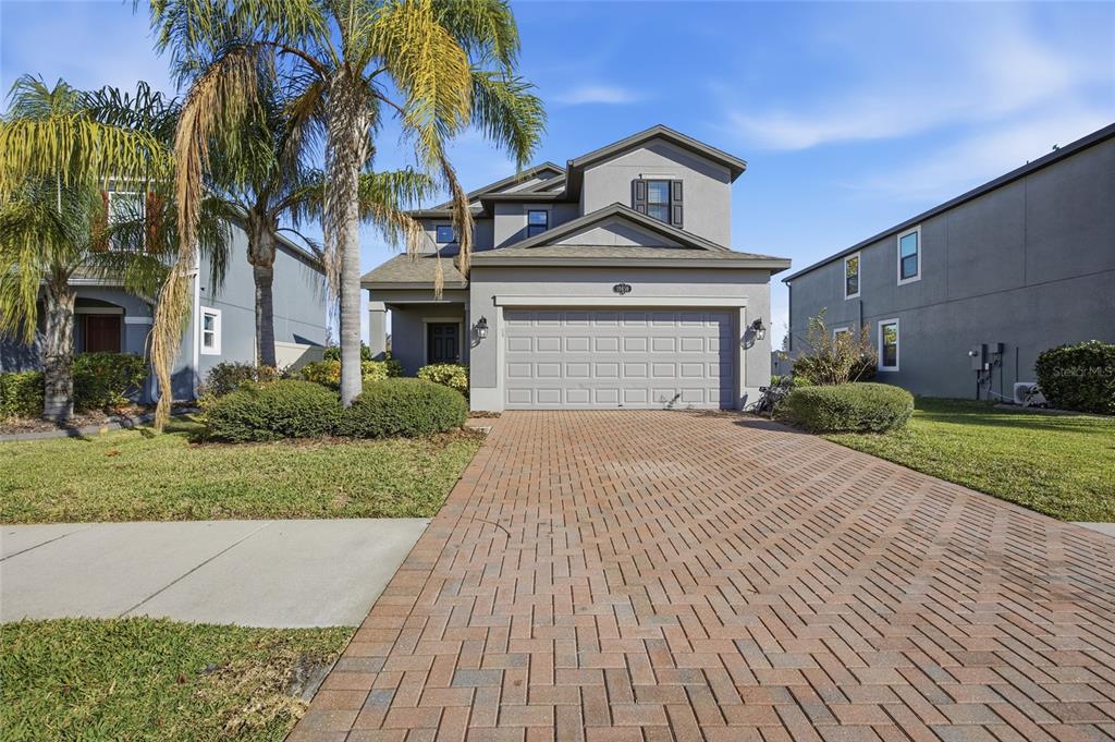 19656 Long Lake Ranch Boulevard Lutz, FL 33558 - Photo 2 of 44 a front view of a house with a yard and garage
