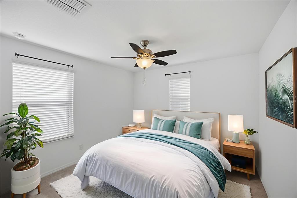 19656 Long Lake Ranch Boulevard Lutz, FL 33558 - Photo 22 of 44 a bedroom with a bed and a potted plant