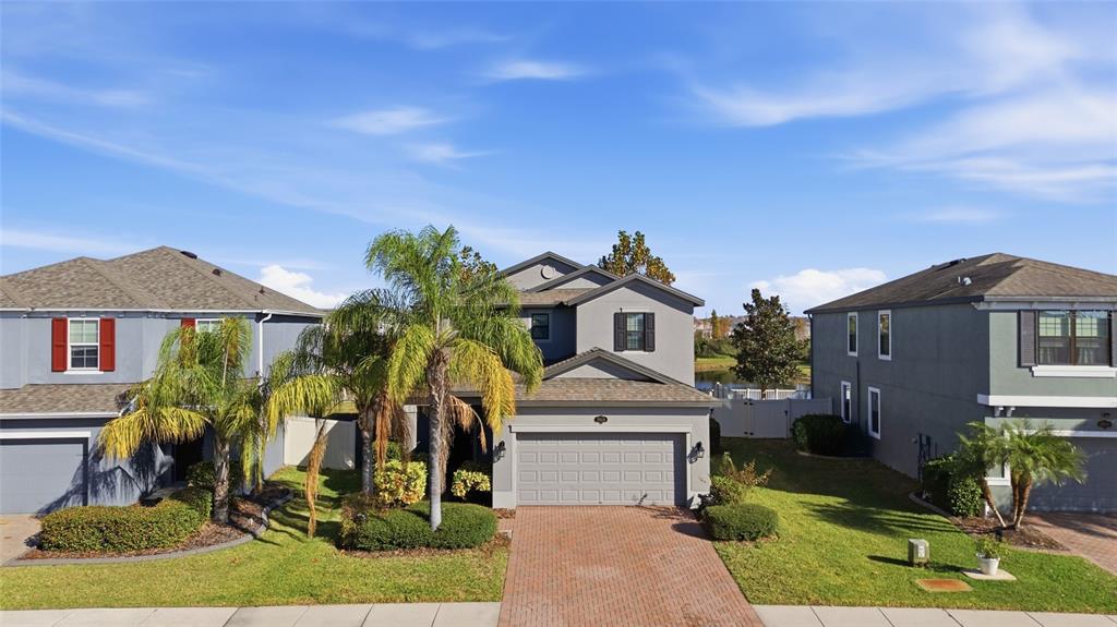 19656 Long Lake Ranch Boulevard Lutz, FL 33558 - Photo 31 of 44 a front view of a house with a yard