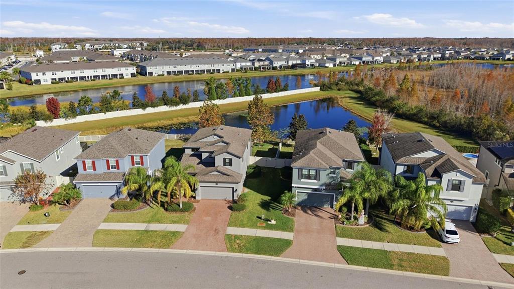 19656 Long Lake Ranch Boulevard Lutz, FL 33558 - Photo 32 of 44 an aerial view of a house with a garden and lake view