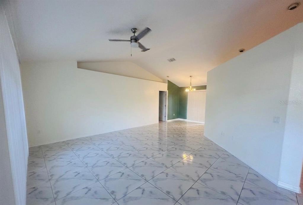 8344 Dorsey Street Spring Hill, FL 34608 - Photo 4 of 10 a view of a hallway with a chandelier fan