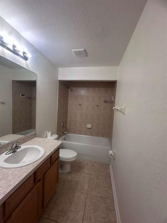 8344 Dorsey Street Spring Hill, FL 34608 - Photo 9 of 10 a bathroom with a sink a toilet and shower