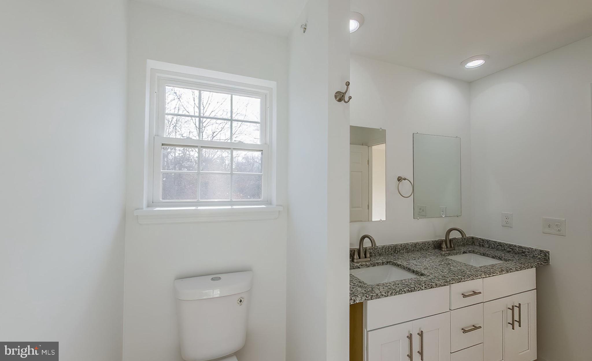 13 Nicole Lane Hazleton, PA 18202 - Photo 16 of 23 a bathroom with a granite countertop sink a toilet and a window