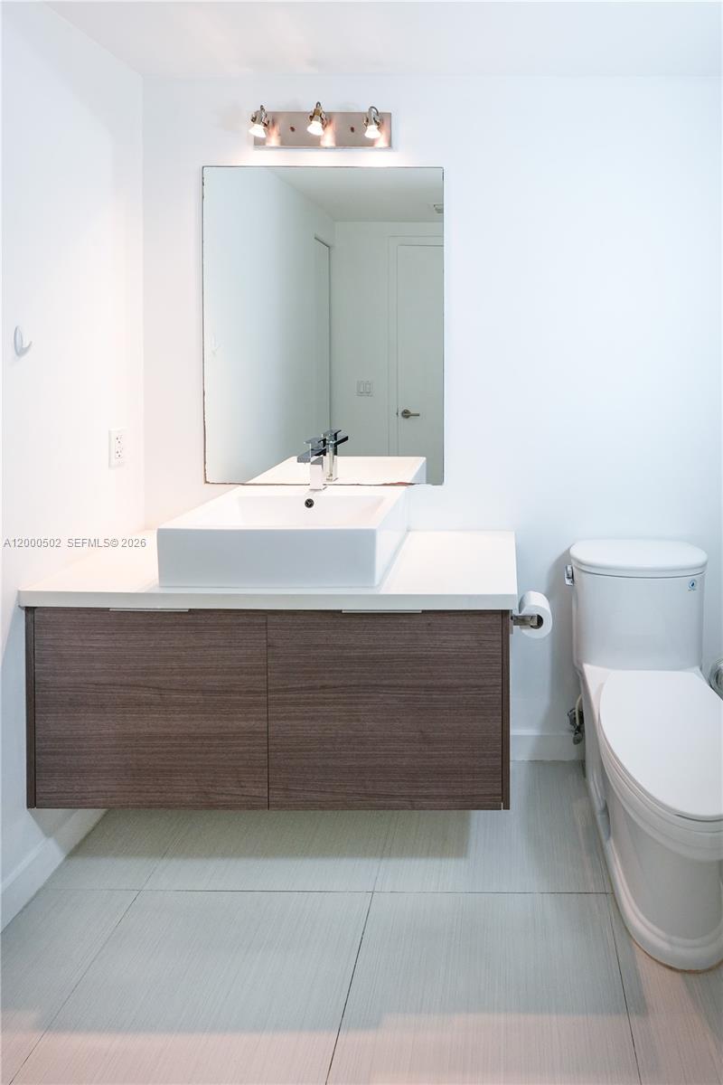 1010 Southwest 2nd Avenue, Unit 606 Miami, FL 33130 - Photo 15 of 46 a bathroom with a sink toilet and mirror