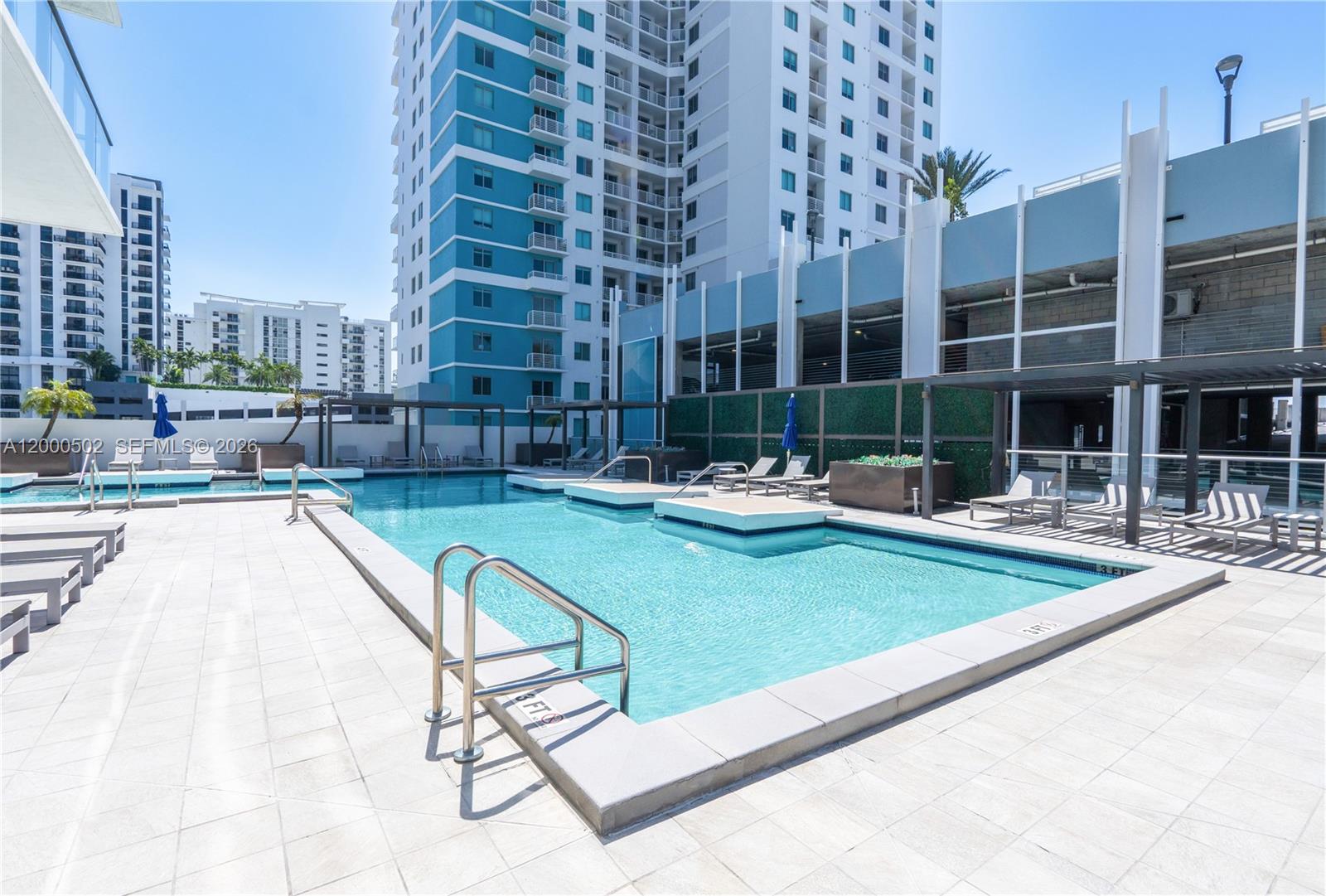 1010 Southwest 2nd Avenue, Unit 606 Miami, FL 33130 - Photo 29 of 46 a swimming pool with outdoor seating and yard