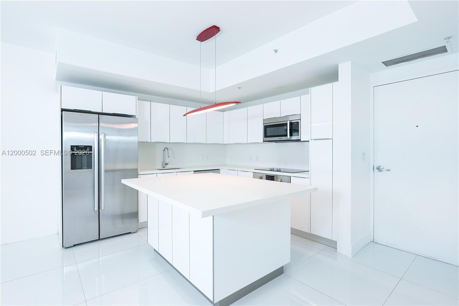 1010 Southwest 2nd Avenue, Unit 606 Miami, FL 33130 - Photo 3 of 46 a kitchen with stainless steel appliances a refrigerator sink and microwave