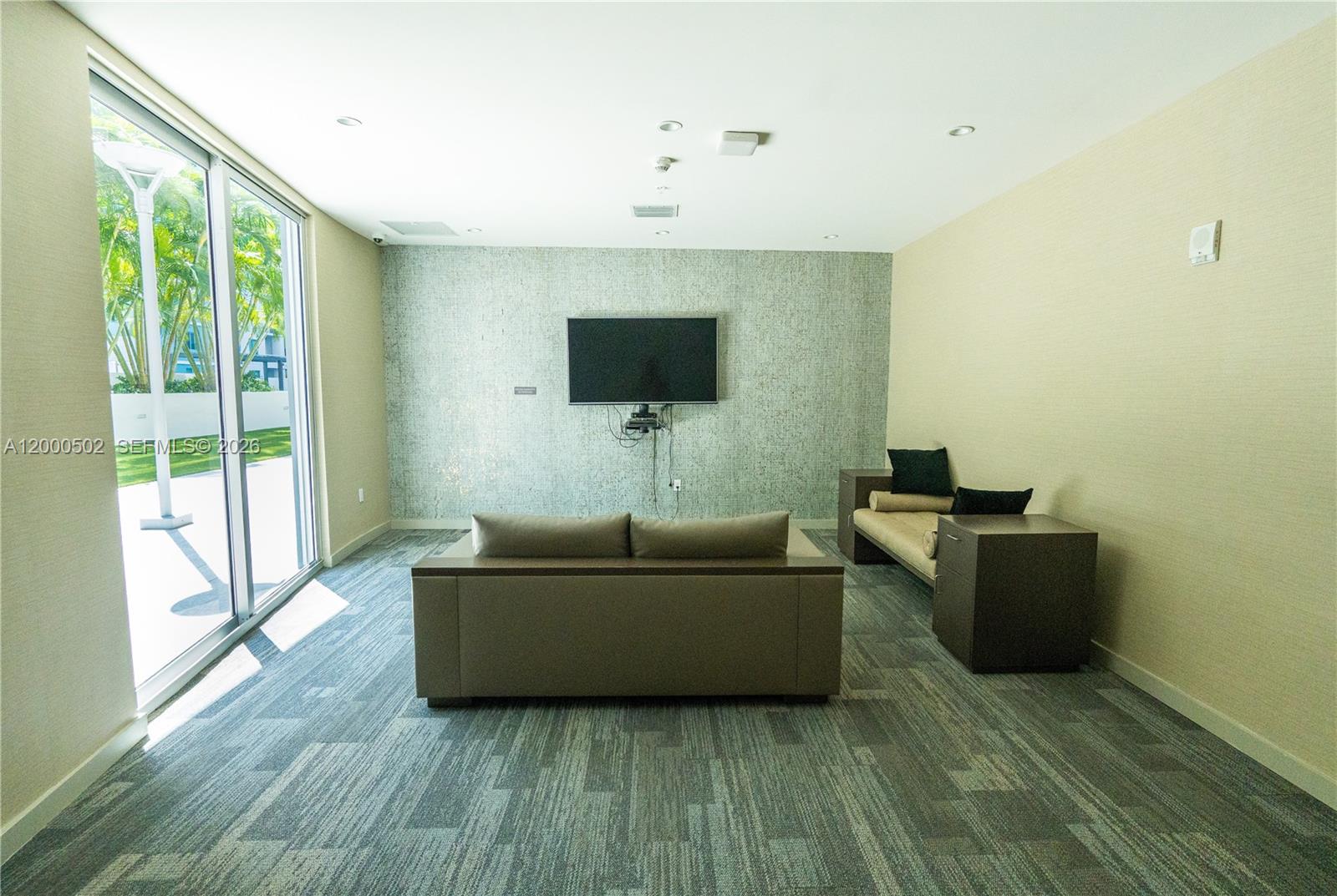 1010 Southwest 2nd Avenue, Unit 606 Miami, FL 33130 - Photo 46 of 46 a living room with furniture and a flat screen tv