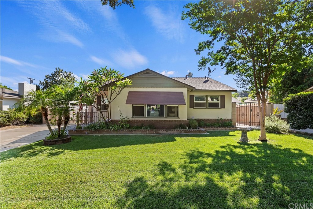 3687 Roslyn Street Riverside, CA 92504 - Photo 1 of 1 a front view of a house with a yard