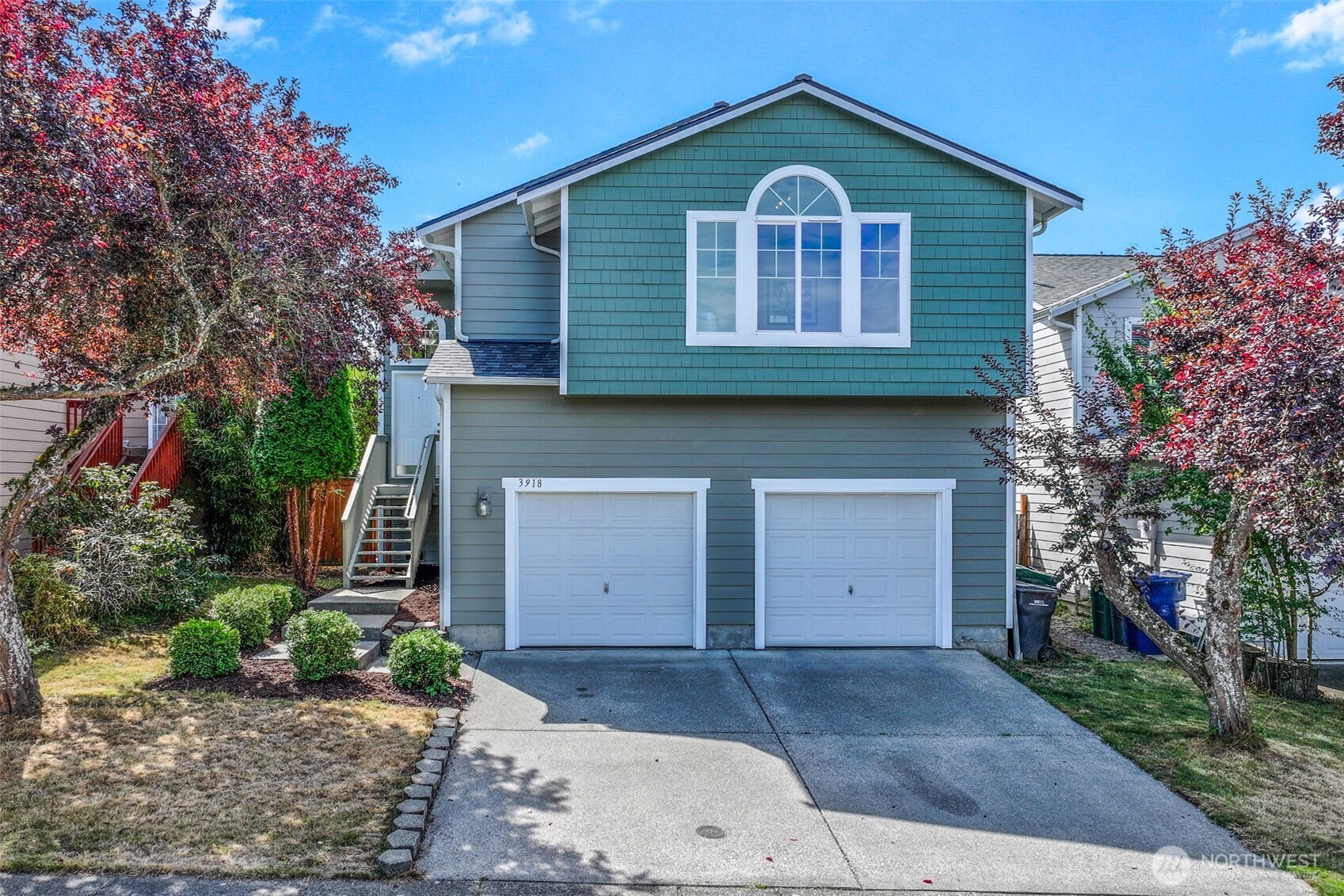 a front view of a house with a yard and garage