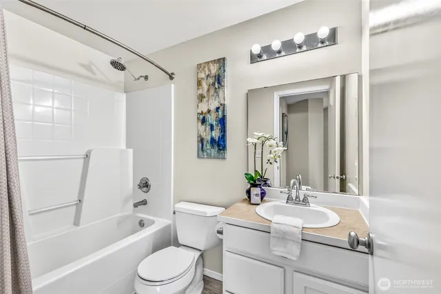 a bathroom with a sink toilet tub and shower