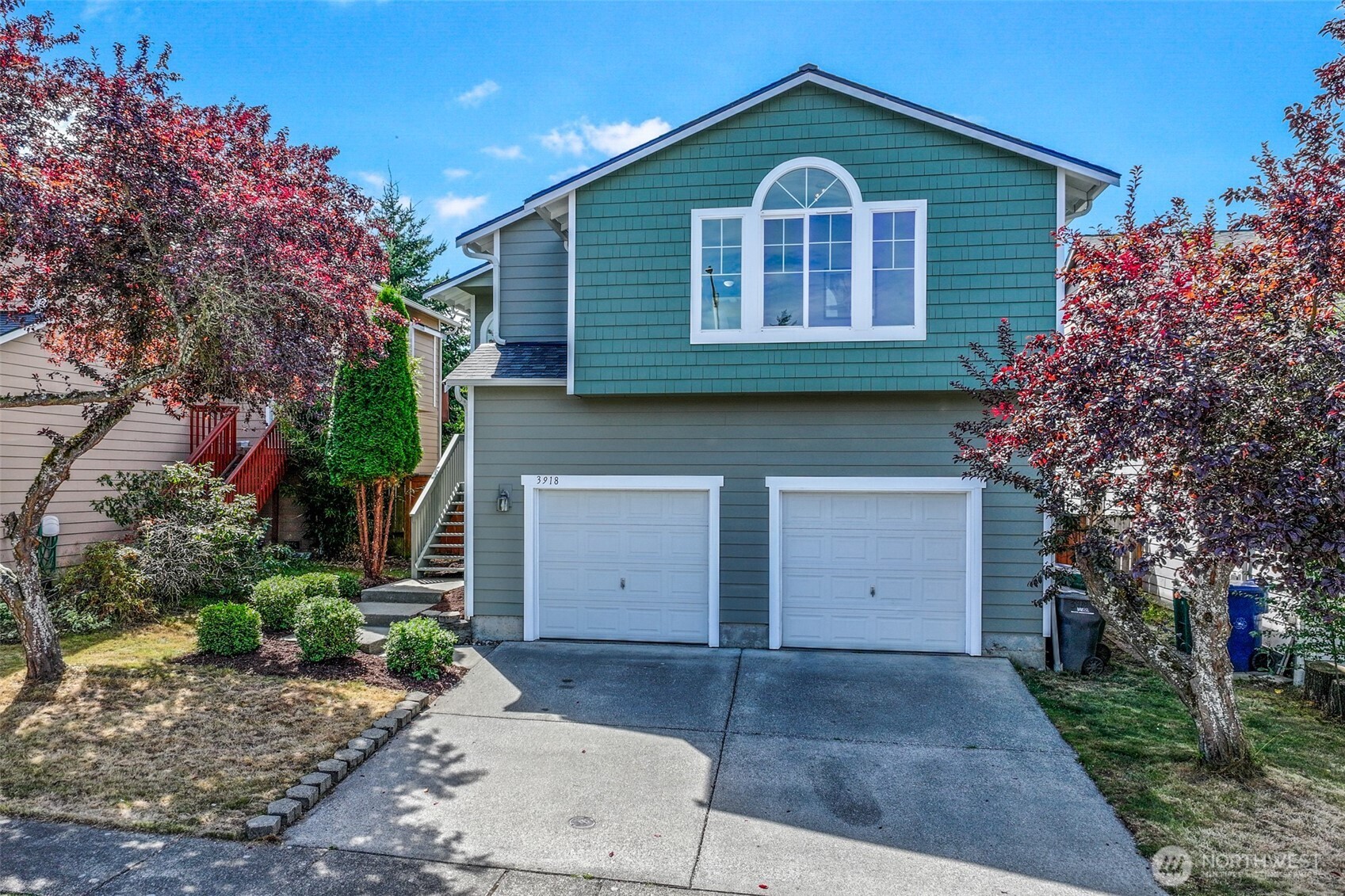 3918 152nd Place Southeast Bothell, WA 98012 - Photo 23 of 31 a front view of a house with a yard and garage
