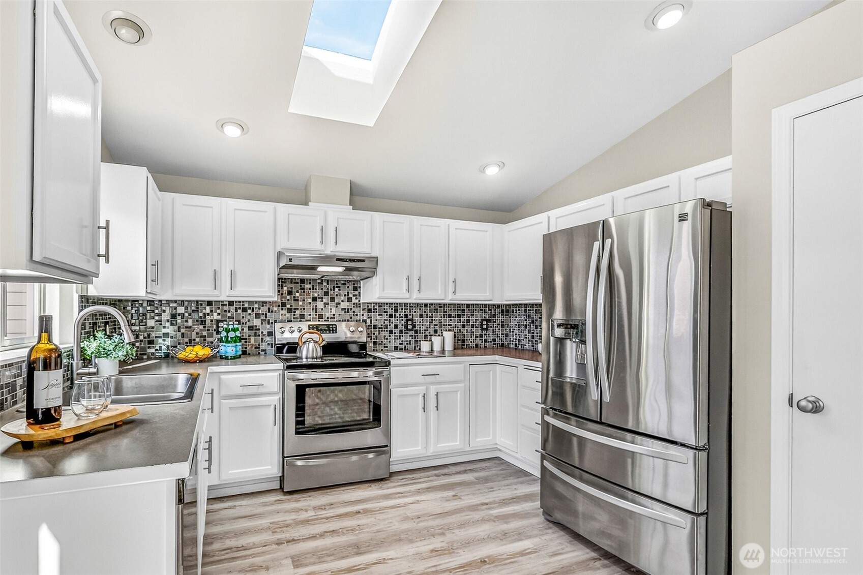 3918 152nd Place Southeast Bothell, WA 98012 - Photo 9 of 31 a kitchen with stainless steel appliances granite countertop a refrigerator stove and sink