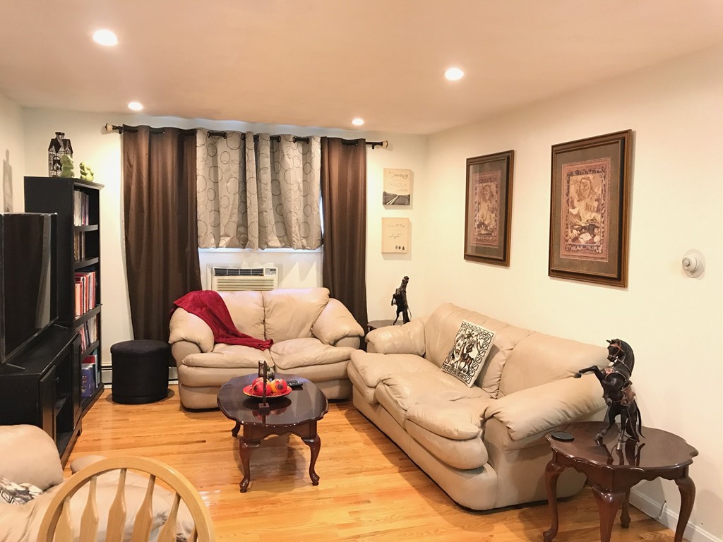 46 Adams Street, Unit A6 Boston, MA 02122 - Photo 3 of 11 a living room with furniture wooden floor and a flat screen tv