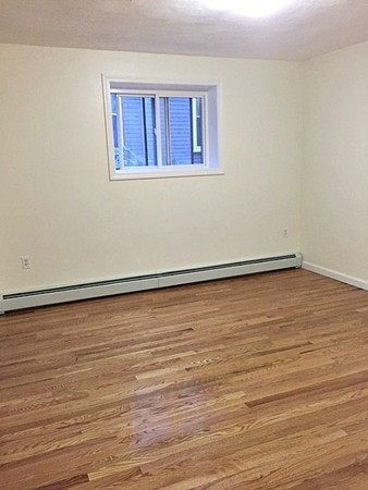 46 Adams Street, Unit A6 Boston, MA 02122 - Photo 9 of 11 a view of an empty room with wooden floor