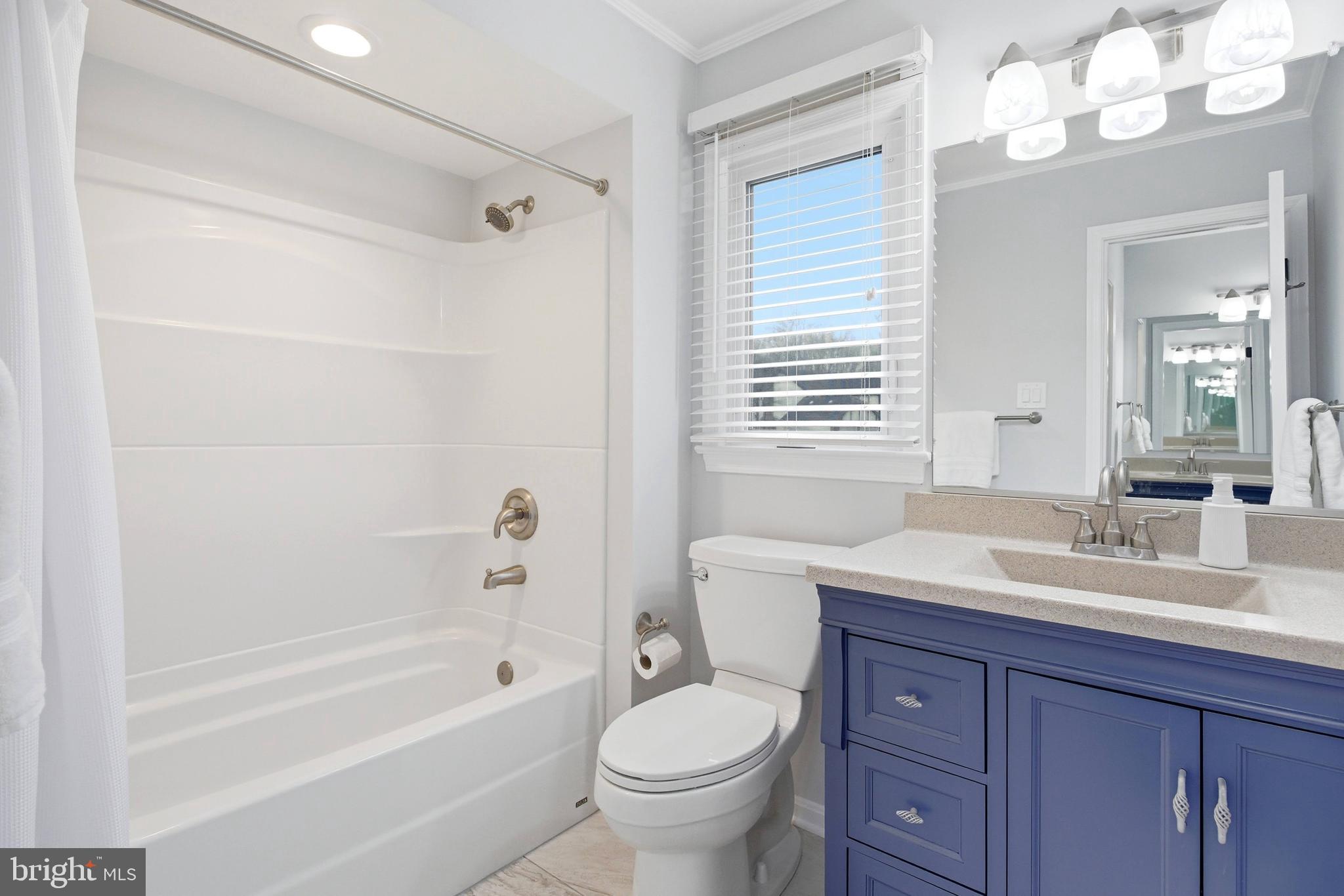 7400 Dorothy Court Springfield, VA 22153 - Photo 18 of 54 a bathroom with a sink a toilet a mirror a vanity a bathtub and shower