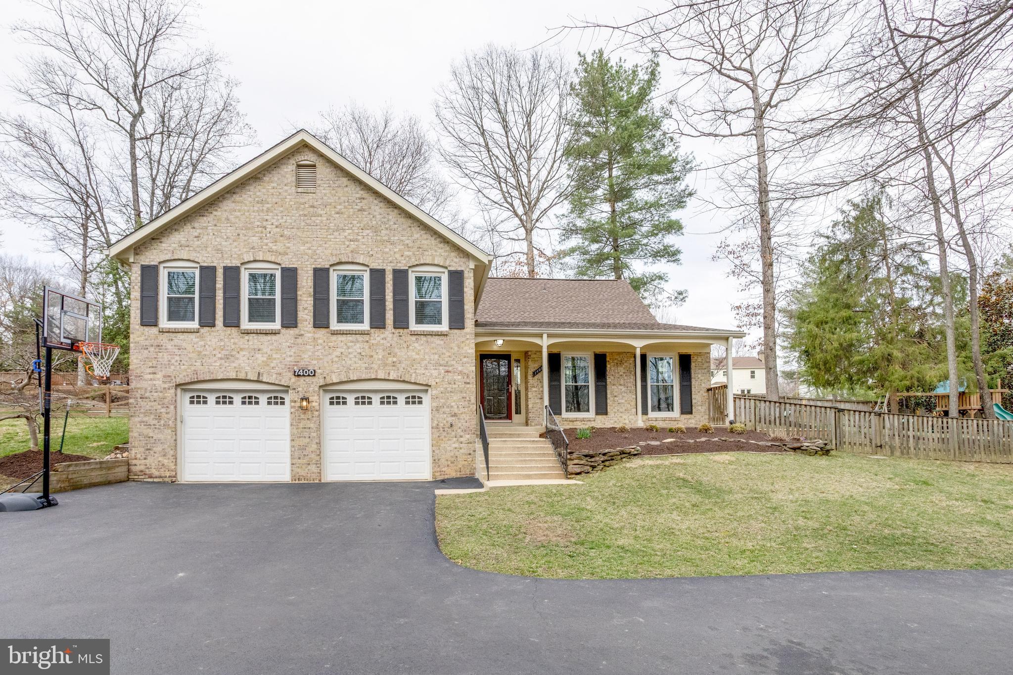7400 Dorothy Court Springfield, VA 22153 - Photo 3 of 54 a front view of a house with a yard and garage