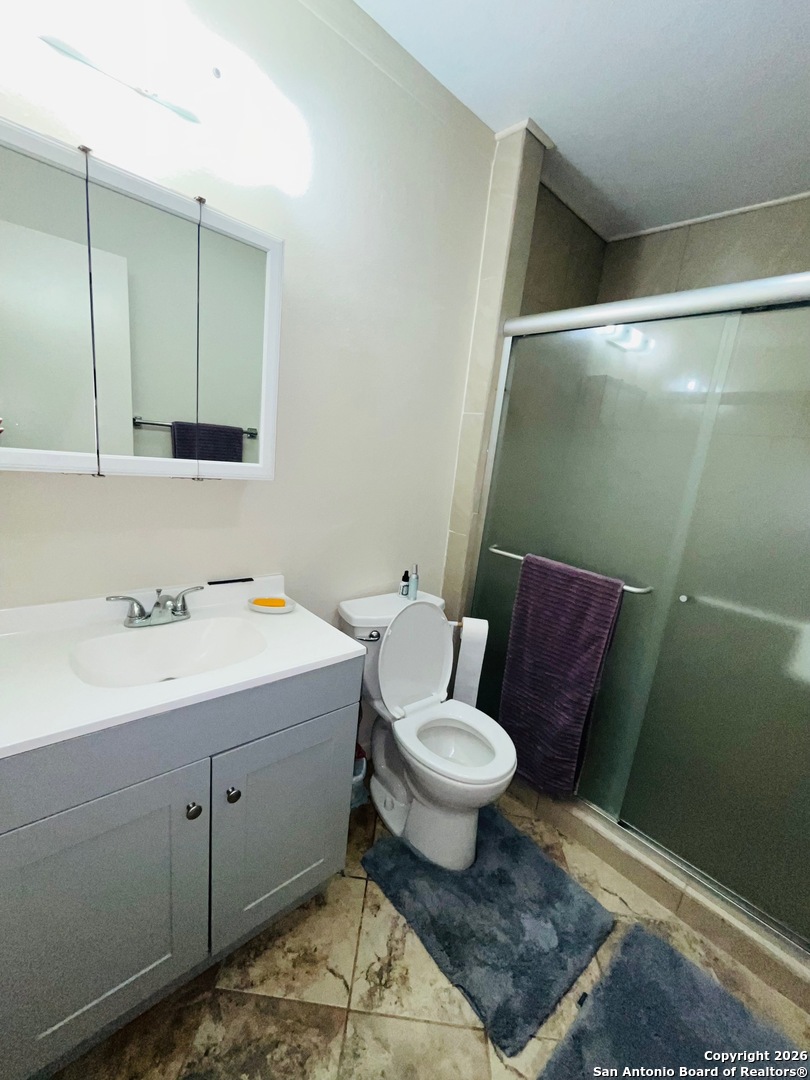 200 West Frio Street Dilley, TX 78017 - Photo 12 of 18 a bathroom with a sink toilet and mirror