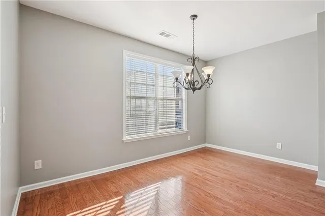 a view of a room with wooden floor and windows