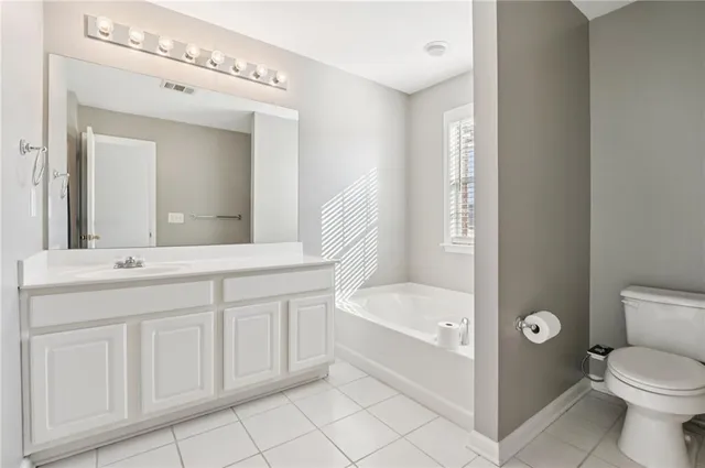 a bathroom with a double vanity sink mirror and toilet