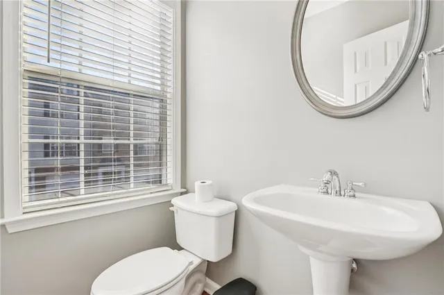 a bathroom with a sink a mirror and a toilet
