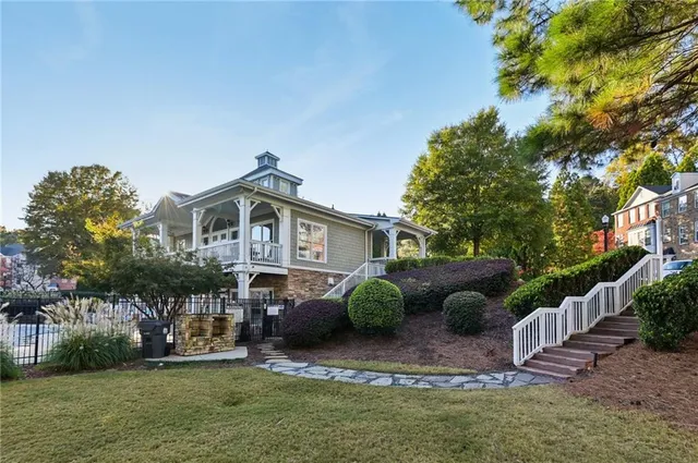 a front view of a house with a garden and plants