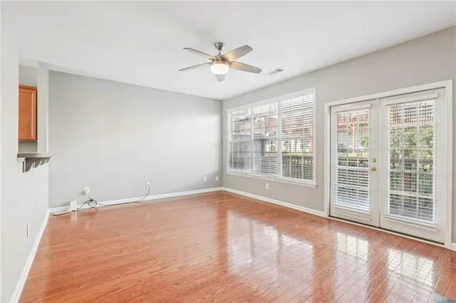 a view of a livingroom with a ceiling fan and window