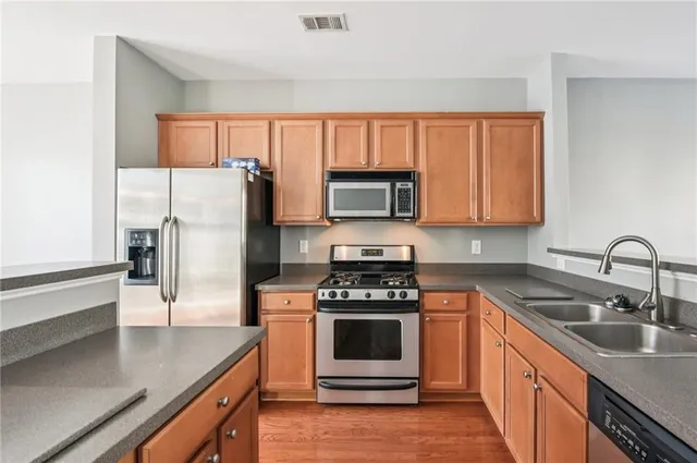 a kitchen with a sink a stove and refrigerator