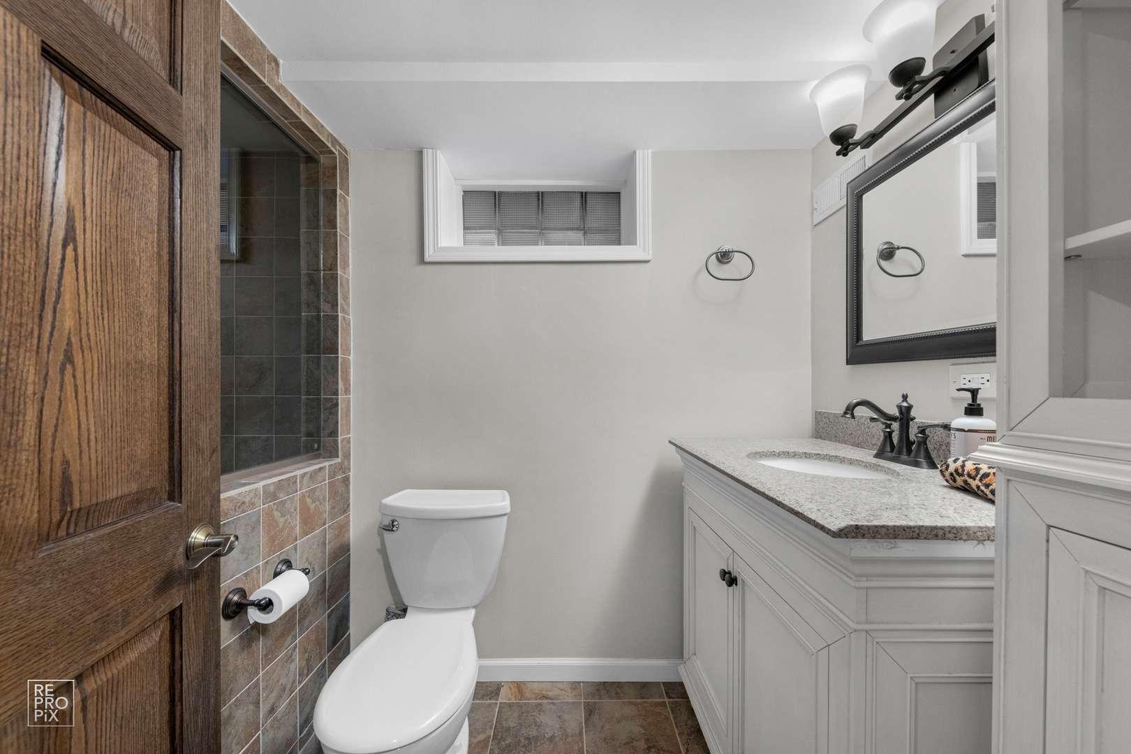 352 Ridge Avenue Clarendon Hills, IL 60514 - Photo 25 of 31 a bathroom with a granite countertop toilet sink and mirror
