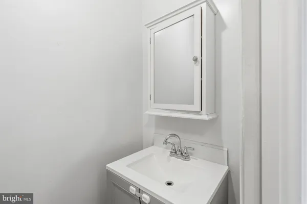 a bathroom with a sink a mirror and vanity