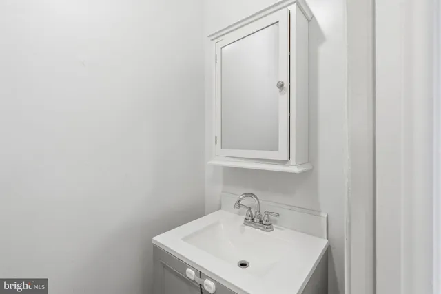 a bathroom with a sink a mirror and vanity