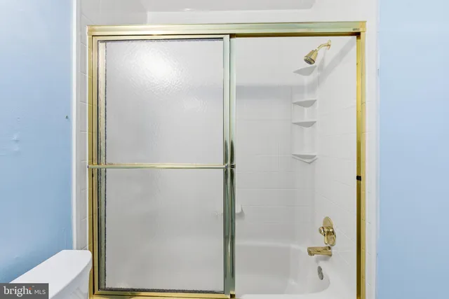 a bathroom with a glass shower door