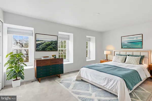 a spacious bedroom with a bed and a window