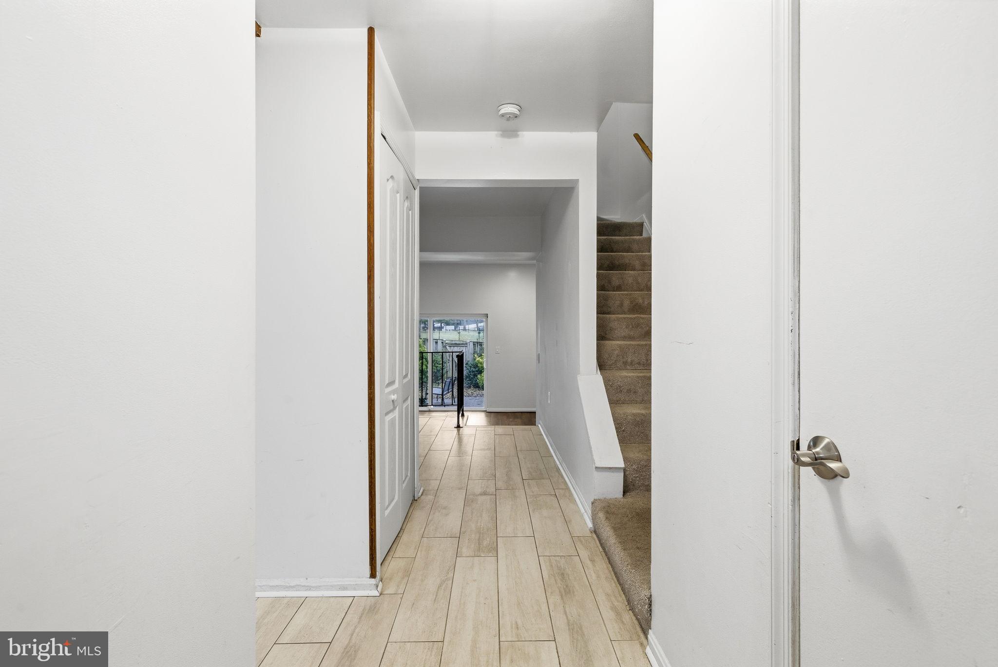 11072 Berrypick Lane Columbia, MD 21044 - Photo 3 of 35 a view of a hallway with wooden floor and staircase