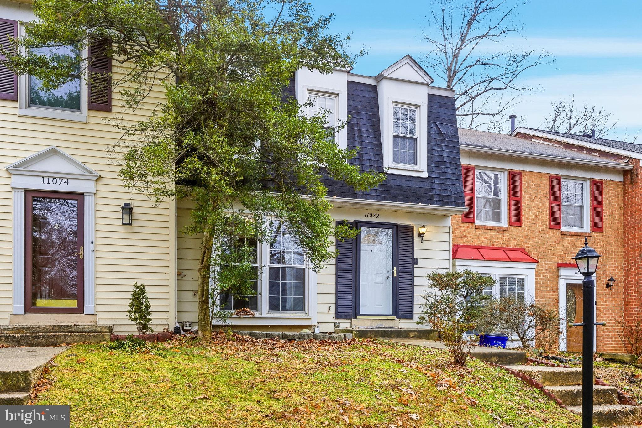 11072 Berrypick Lane Columbia, MD 21044 - Photo 35 of 35 a view of a brick house with many windows and garage