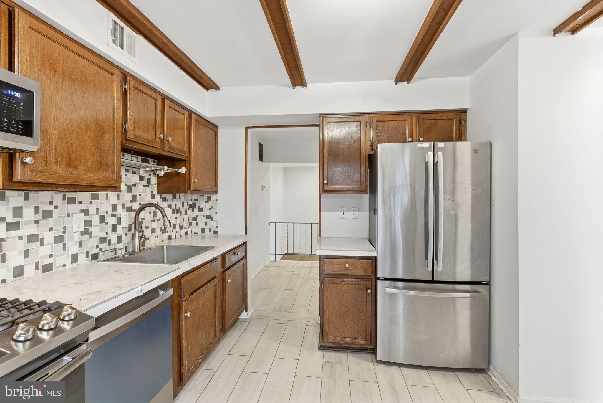 11072 Berrypick Lane Columbia, MD 21044 - Photo 6 of 35 a kitchen with a refrigerator and a sink