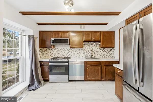 a kitchen with stainless steel appliances granite countertop a stove and a refrigerator