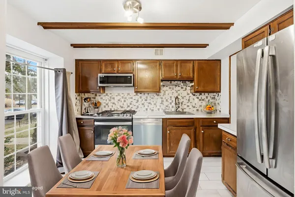 a kitchen with stainless steel appliances granite countertop a refrigerator and a stove
