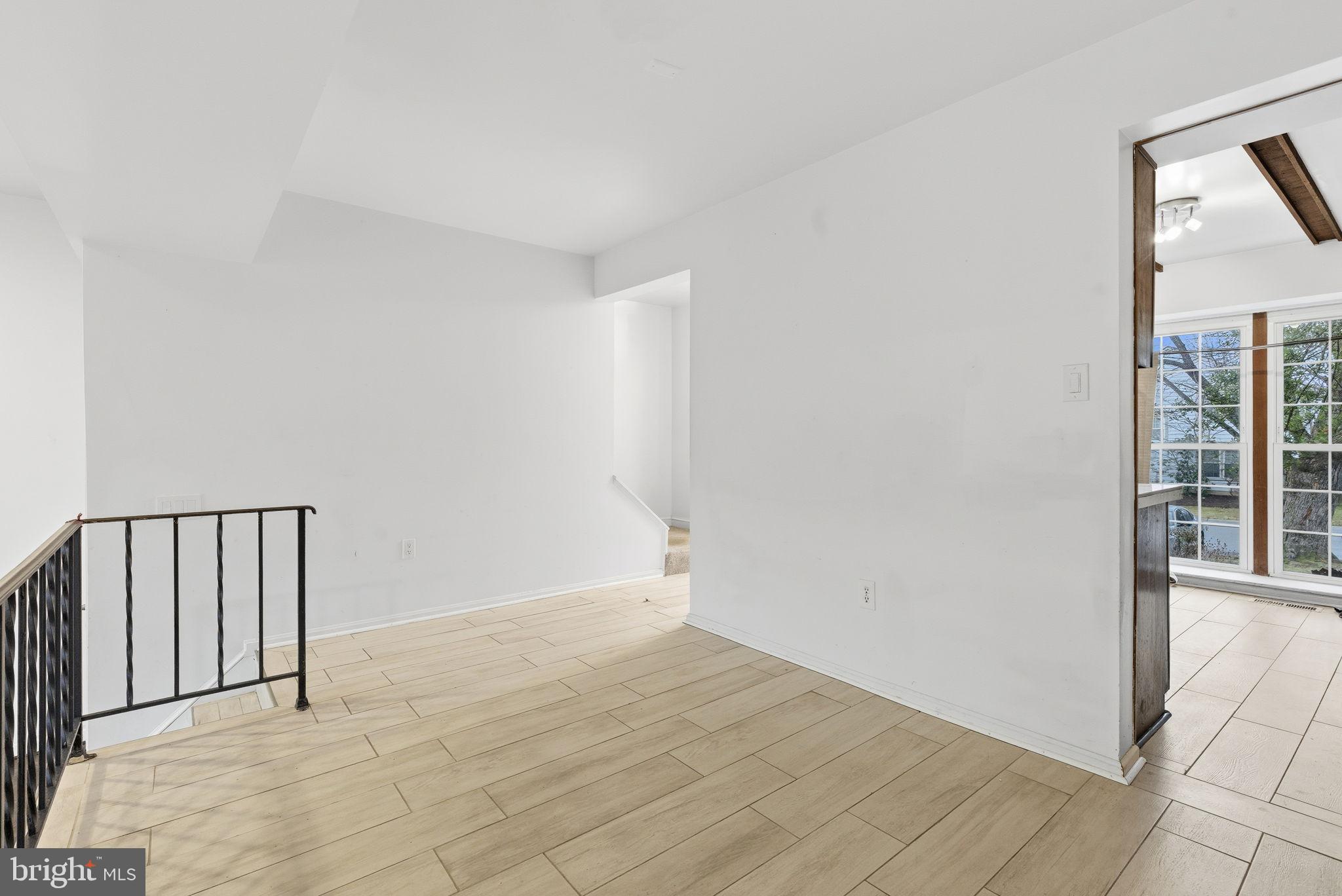 11072 Berrypick Lane Columbia, MD 21044 - Photo 10 of 35 a view of an empty room with wooden floor and a window