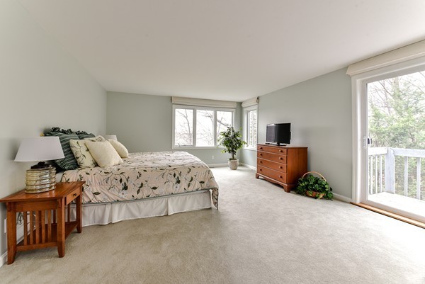 14 Farm Hill Road Natick, MA 01760 - Photo 13 of 27 a spacious bedroom with a bed and a view of balcony